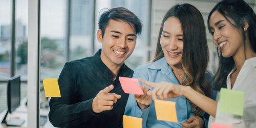 A group of happy office workers discussing human resource needs at the office.