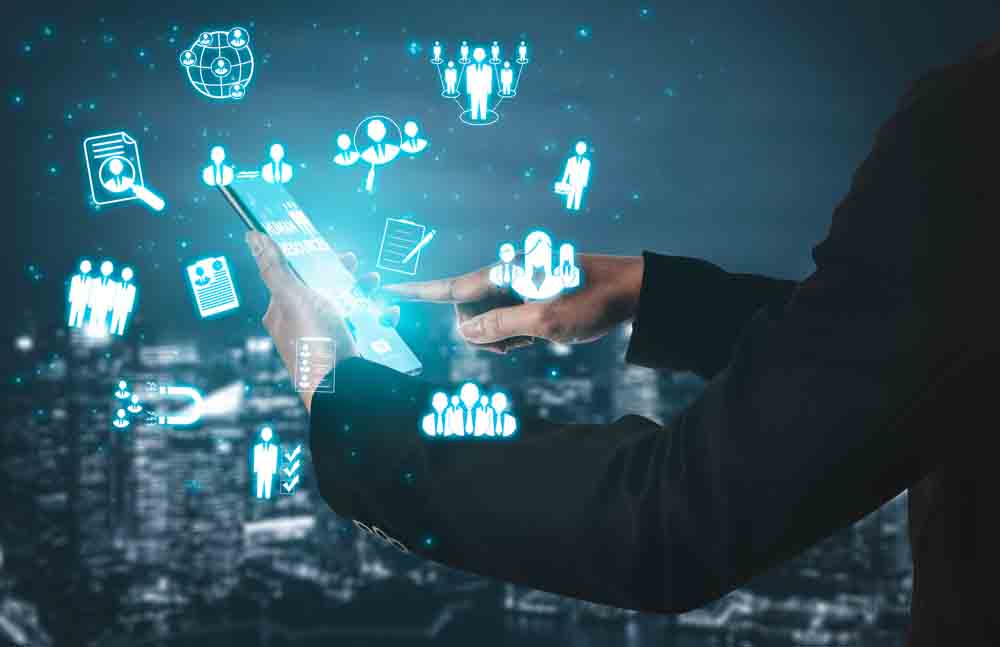 A man in a black suit using a holographic CRM platform to manage customer relationships.