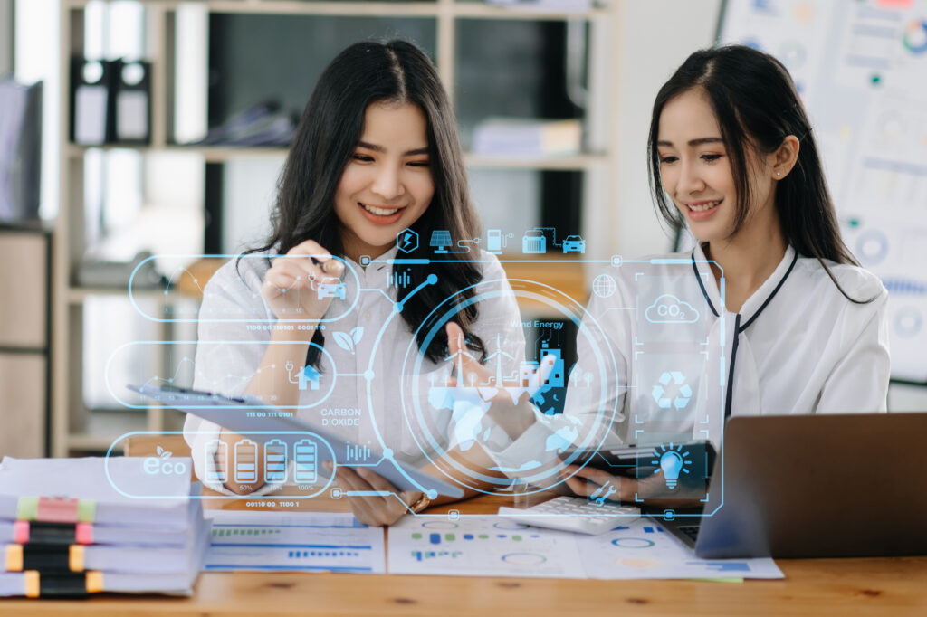 Two women in an office using business automation to boost productivity