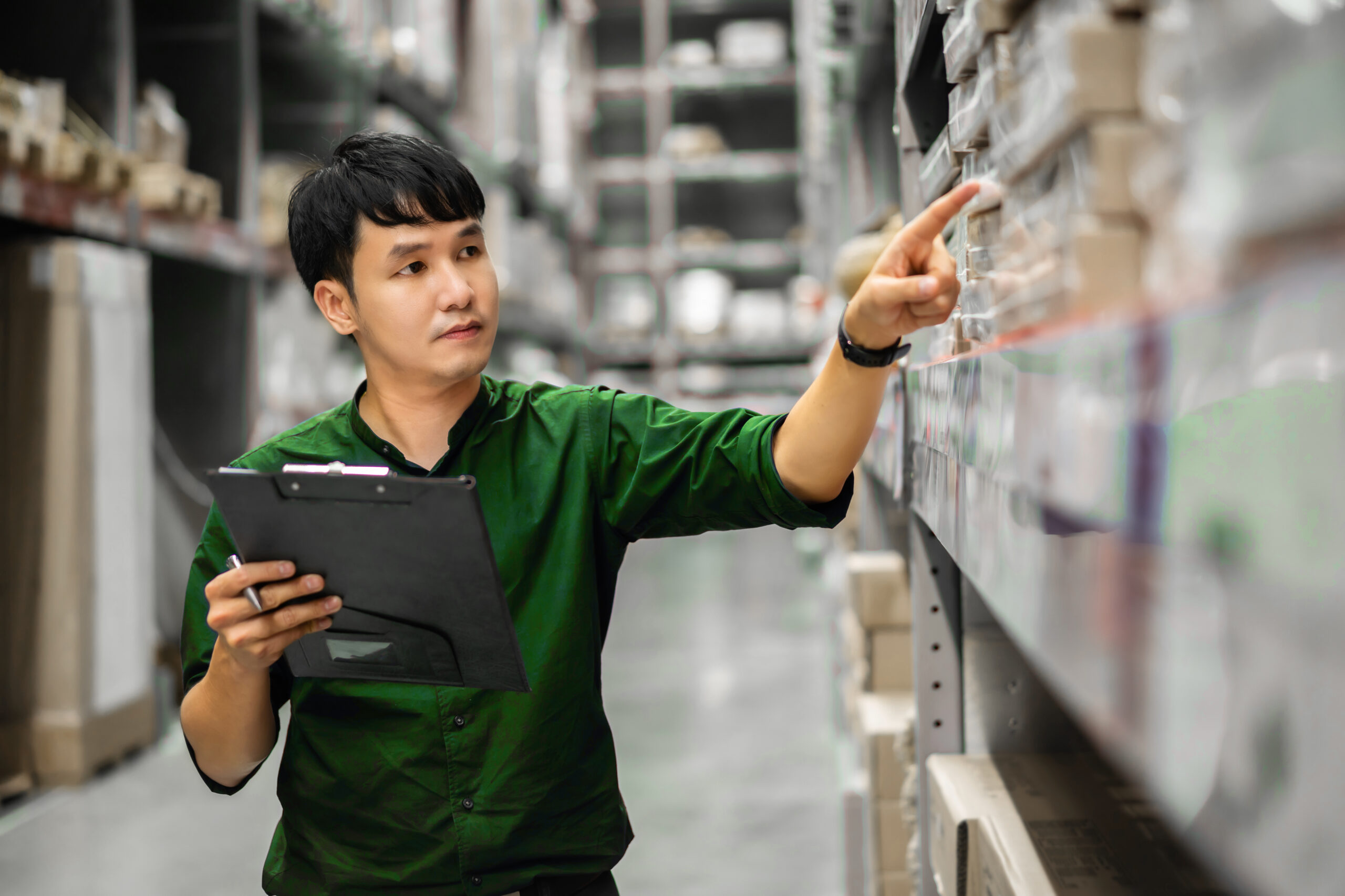 Warehouse management officer checking inventory